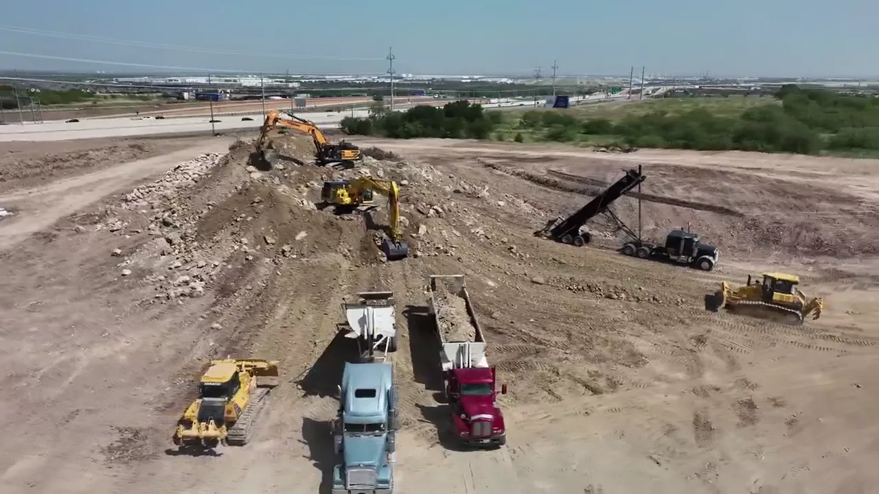 Excavators and haul trucks loading limestone on a Fort Worth project running 400 loads a day
