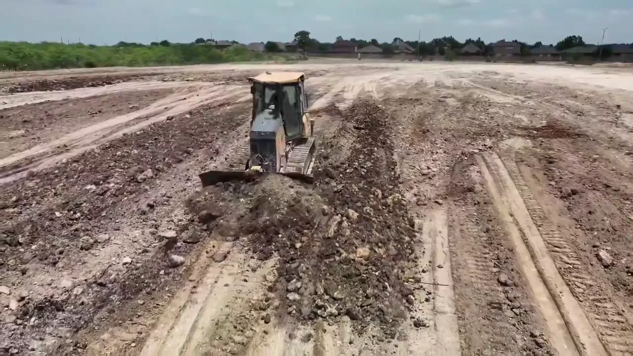 Haul trucks working a North Fort Worth homebuilding pad during a 300,000 cubic yard common fill import